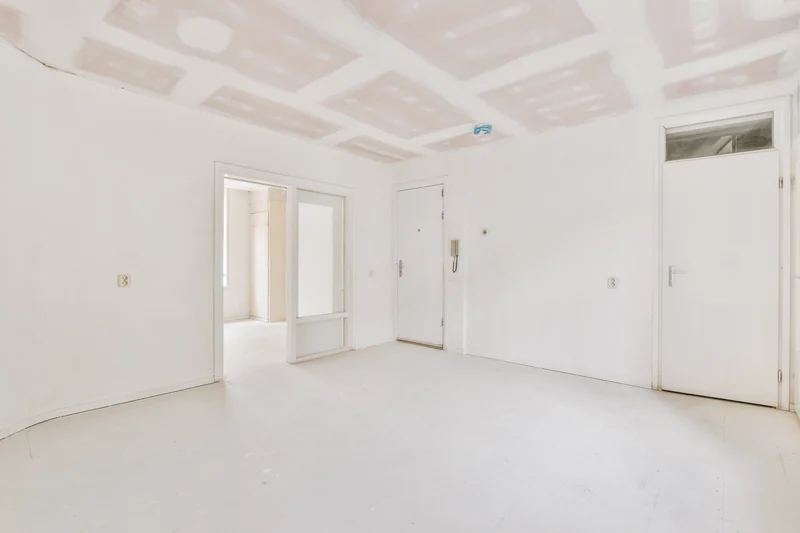 Taped room with the doors hung and the ceiling finished