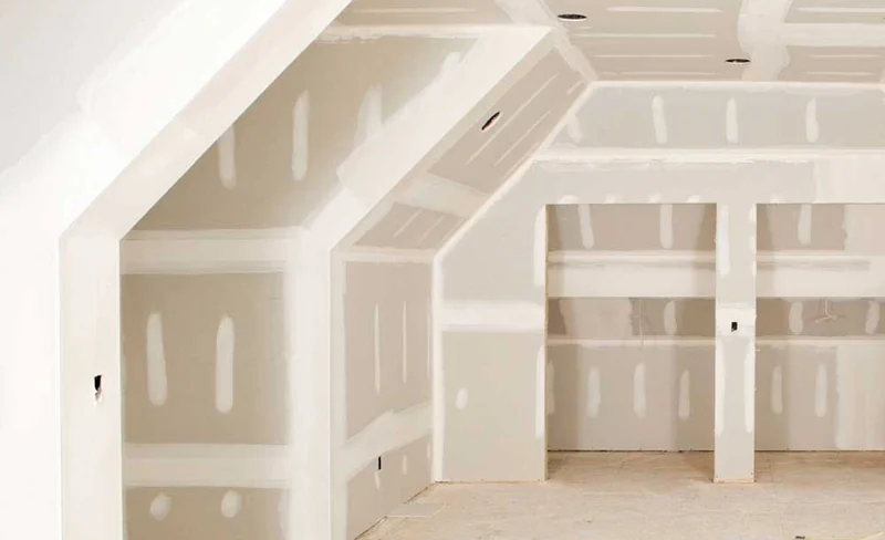 Angled dormer ceilings with built-in niches framed and boarded