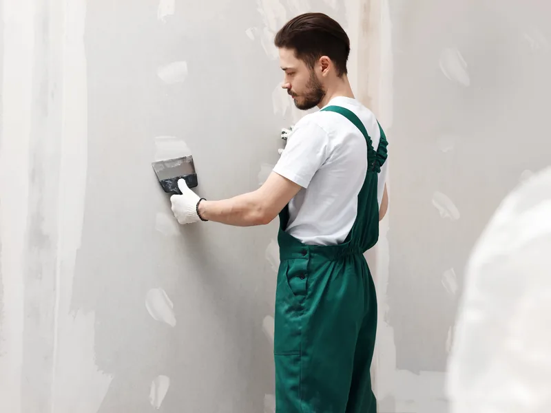 Drywall repair smoothed flush with the surrounding wall